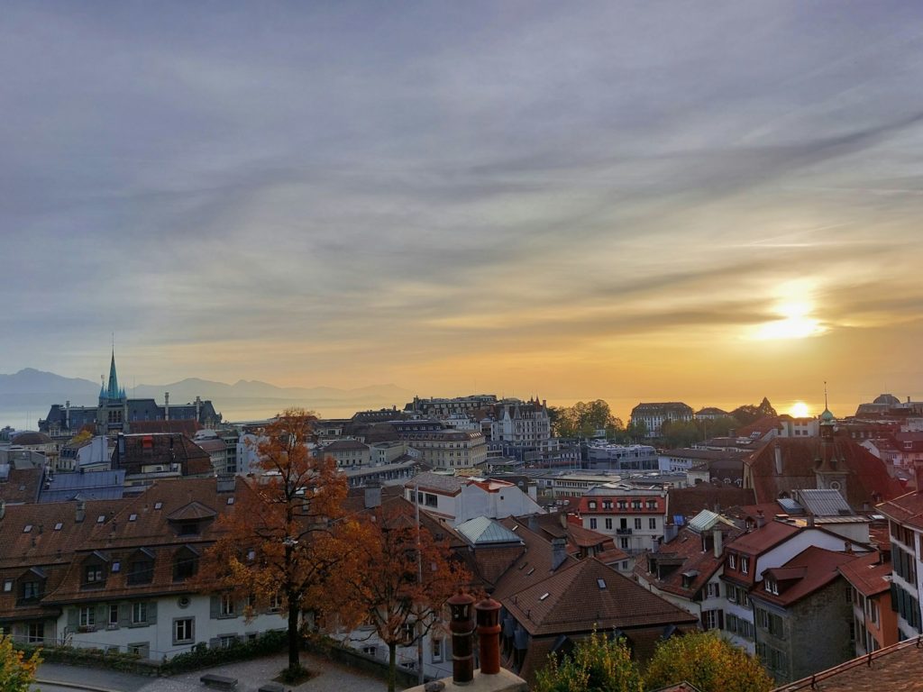a view of a city with a sunset in the background