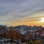 a view of a city with a sunset in the background
